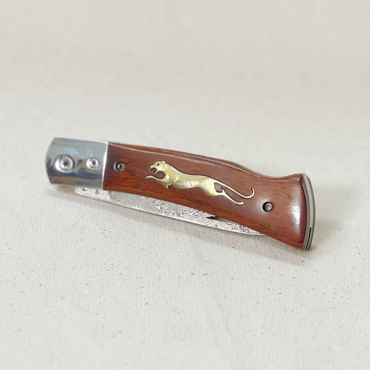 Wooden Cheetah Pocket Knife with a Damascus steel blade and brass cheetah inlay in the wood handle