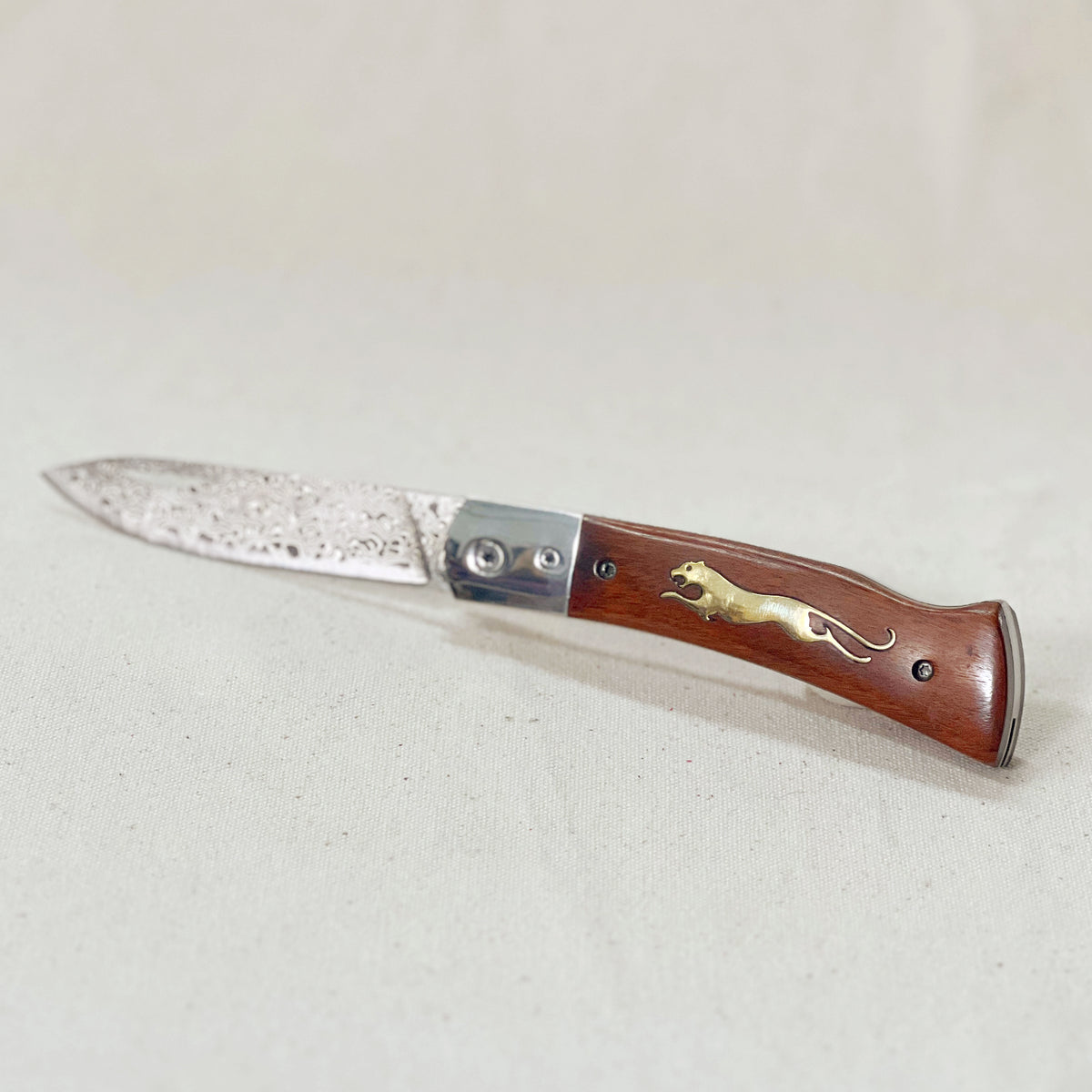 Wooden Cheetah Pocket Knife with a Damascus steel blade and brass cheetah inlay in the wood handle