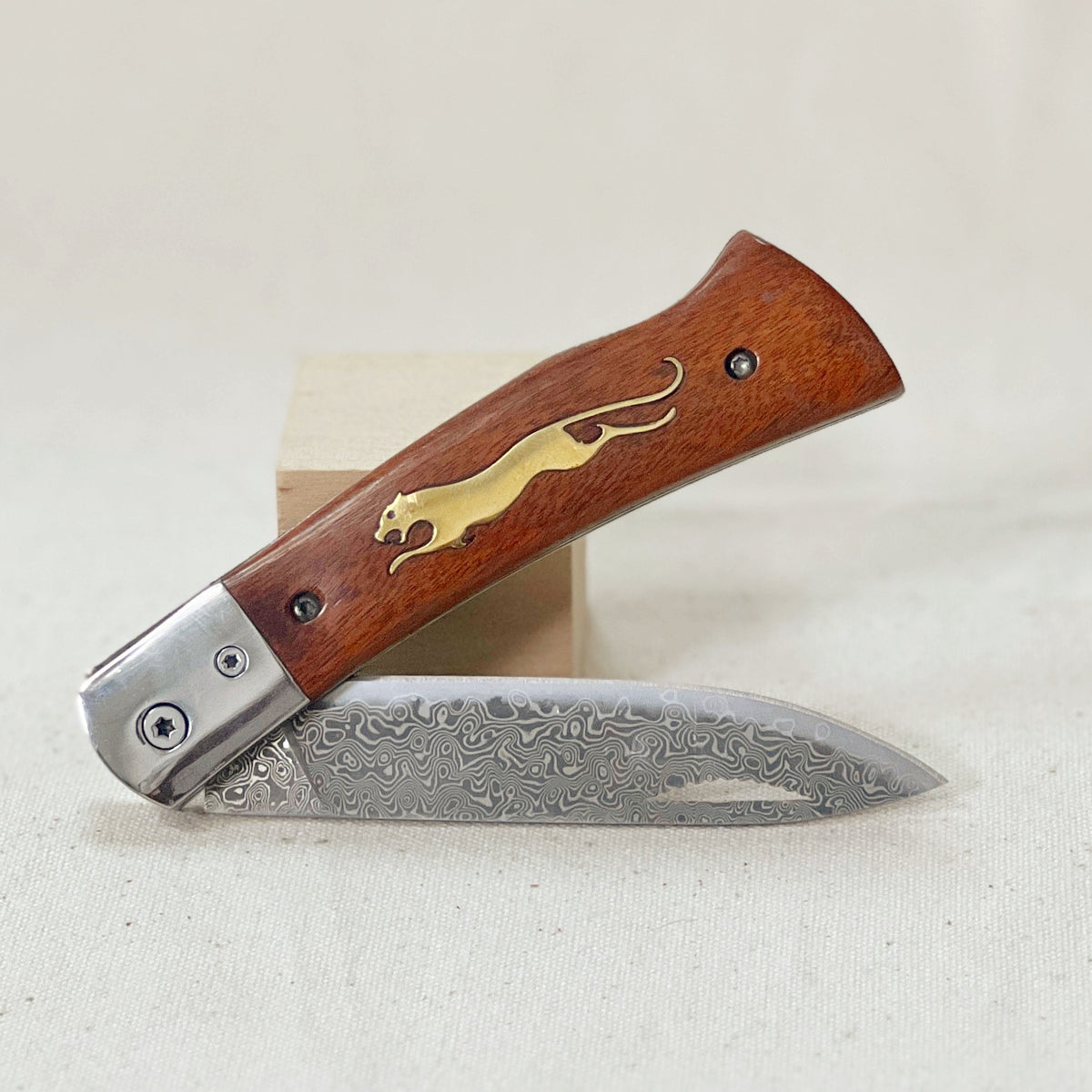 Wooden Cheetah Pocket Knife with a Damascus steel blade and brass cheetah inlay in the wood handle