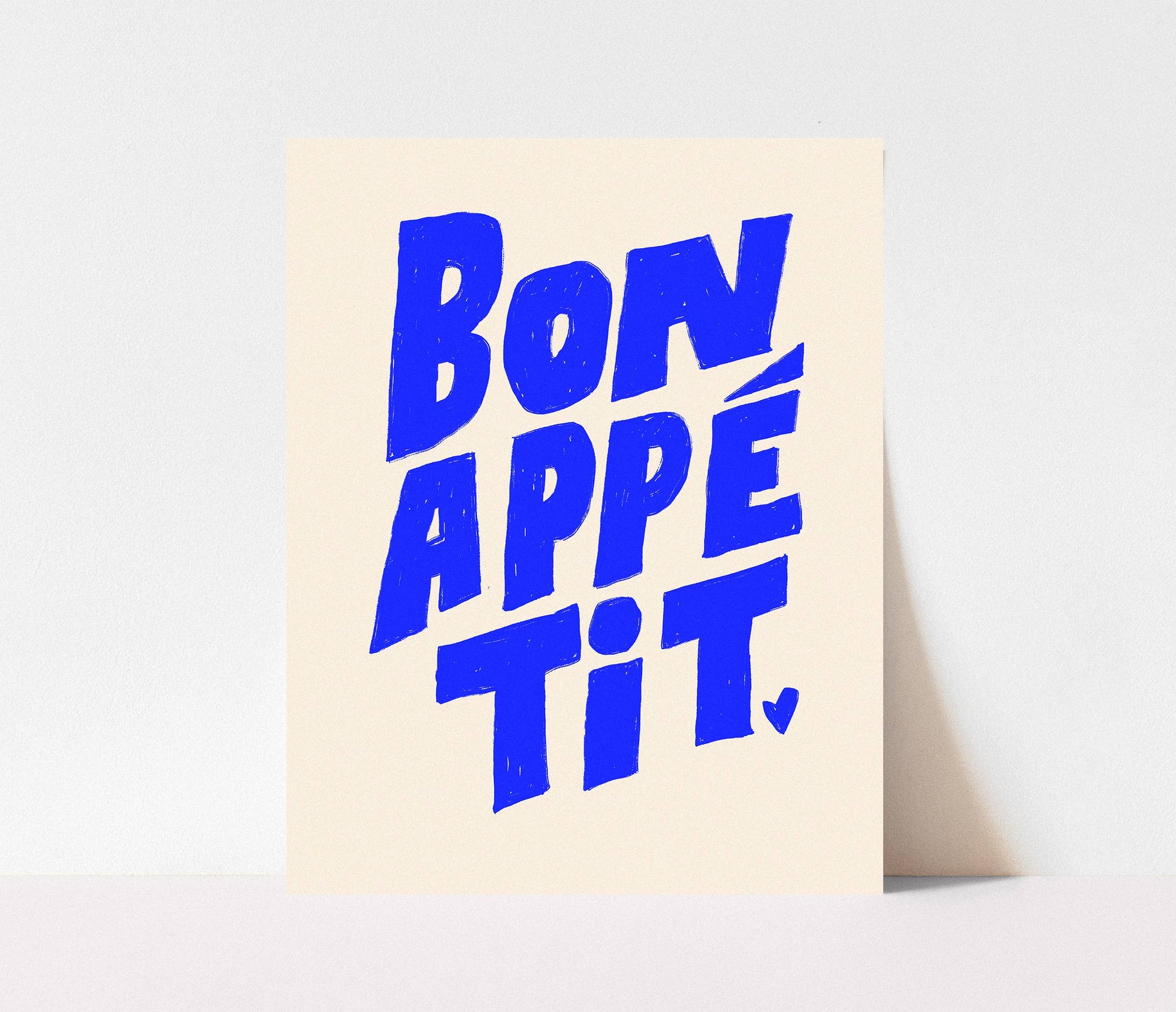 Add charm to your kitchen with this Bon Appétit art print. Hand-lettered in bold blue on a white background, it's a fresh and playful addition to any space.