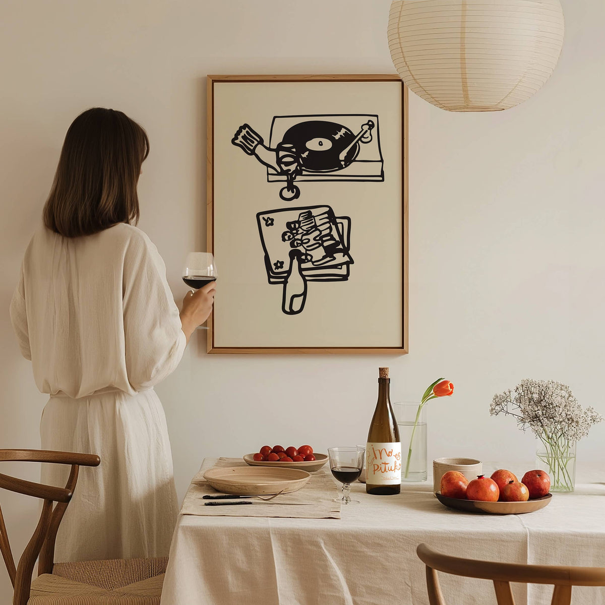 This piece of art celebrates the perfect night in. This unframed art print is a charming illustration of the ultimate combination: wine and vinyl. With its scribbley line texture, it has a wonderfully relaxed feel and modern aesthetic that’s a perfect addition to a living room, bar cart, or cozy reading nook. Perfect for wine lovers and foodies.