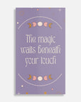 Purple card with moon phases and text 'The magic waits beneath your touch' on a white background
