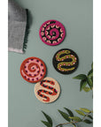 Set of 4 beaded coasters from Danica Studio’s Gardenland collection featuring bold snakes in earthy greens with pops of pink and red. Durable and eye-catching.