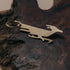 Brass roadrunner bottle opener keychain on dark burl wood