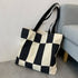 This black and white canvas tote brings a bold, modern feel to your everyday essentials. The striking colorblock design adds visual flair, while the sturdy canvas construction makes it a reliable pick for workdays, errands, or quick weekend adventures. Simple, graphic, and easy to carry, it’s a timeless staple with a fresh twist.