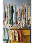 Add charm and protection to your kitchen with the Amulet Embroidered Dishtowel. Featuring insects, reptiles, flowers, and feathers in vibrant hues with playful tassels.