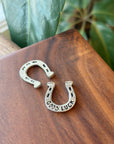 Carry around some good luck! This Good Luck Coin is the perfect little addition to carry around in your bag or decorate little spaces around your home. The front of the coin features a horseshoe and the back of the coin reads "Good Luck". Fine hand-crafted pewter, made in Canada.