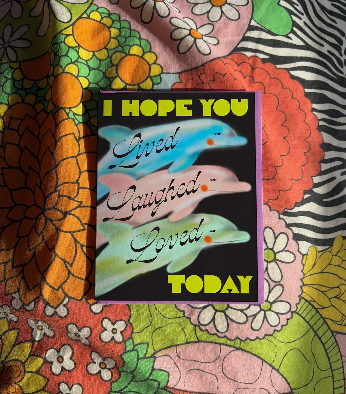 Colorful fabric with a motivational card featuring dolphins and text.