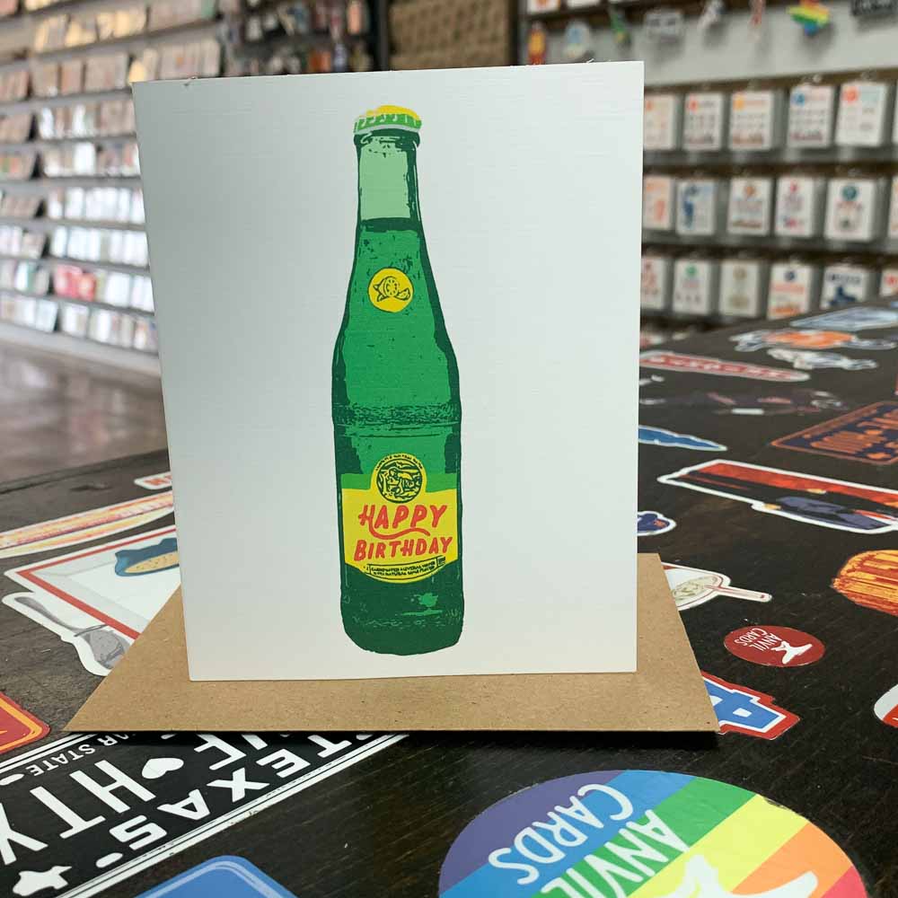Cheers to another trip around the sun with this handmade birthday card featuring a playful illustration of the beloved Topo Chico! Perfect for the bubbly, fun-loving person in your life. Say 'feliz cumpleaños' in style with this quirky greeting card.