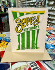 Zest up your birthday wishes with this Zappy Birthday greeting card! Made in Houston, Texas, this card features a bag of Zapp's Chips in the flavor Cajun Dill Gator-Tators with the phrase "Zappy Birthday!" Blank inside, perfect for adding your own unique touch. Created by real hands in Houston, Texas.