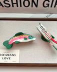 Make a playful, outdoorsy statement with this rainbow trout-shaped hair claw clip. Crafted from smooth acetate, it’s lightweight yet secure, adding a whimsical, nature-inspired touch to your look. Perfect for anglers, animal lovers, or anyone who enjoys a quirky, eye-catching accessory.