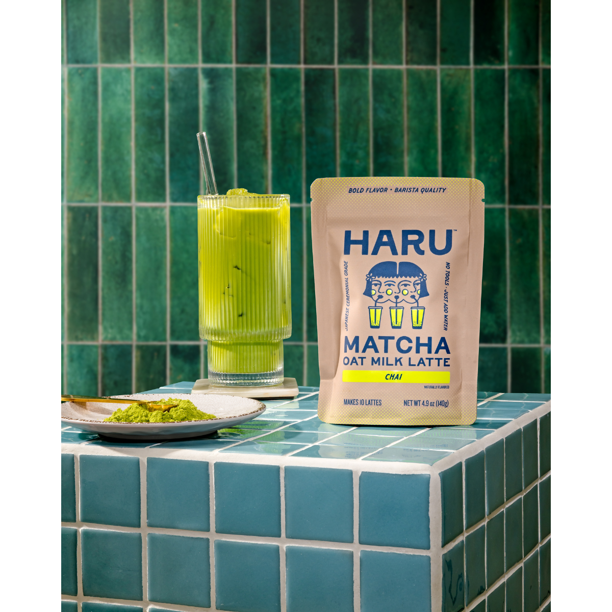 Haru Matcha Oat Milk Latte package on a tiled surface with a green drink.