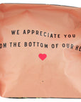 Pink bag with text and a heart symbol on a white background