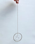 Bring a little sparkle and magic into your home with Prism Ring Suncatchers. Each piece features a golden ring with a prism suspended at its center, designed to catch sunlight and scatter tiny rainbows across your walls and floors. Hang it in a bright window or on a wall to add a touch of light-filled beauty to your space.
