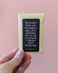Fortune card set with a black card and beige envelope against a pink background