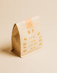Side by Side Chai Tea Latte Mix packaging on a beige background
