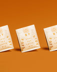Three packages of Side by Side Chai Tea Latte Mix on an orange background