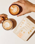 Two hands holding mugs