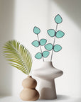 Bring a pop of color and artistry to your home with this handcrafted stained glass gumdrop eucalyptus stem by Samara Designs Studio. This stem is made from beautiful transparent seafoam green stained glass, cut and assembled by hand to create a lasting botanical accent that will never wilt or fade.