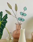 Bring a pop of color and artistry to your home with this handcrafted stained glass gumdrop eucalyptus stem by Samara Designs Studio. This stem is made from beautiful transparent seafoam green stained glass, cut and assembled by hand to create a lasting botanical accent that will never wilt or fade.