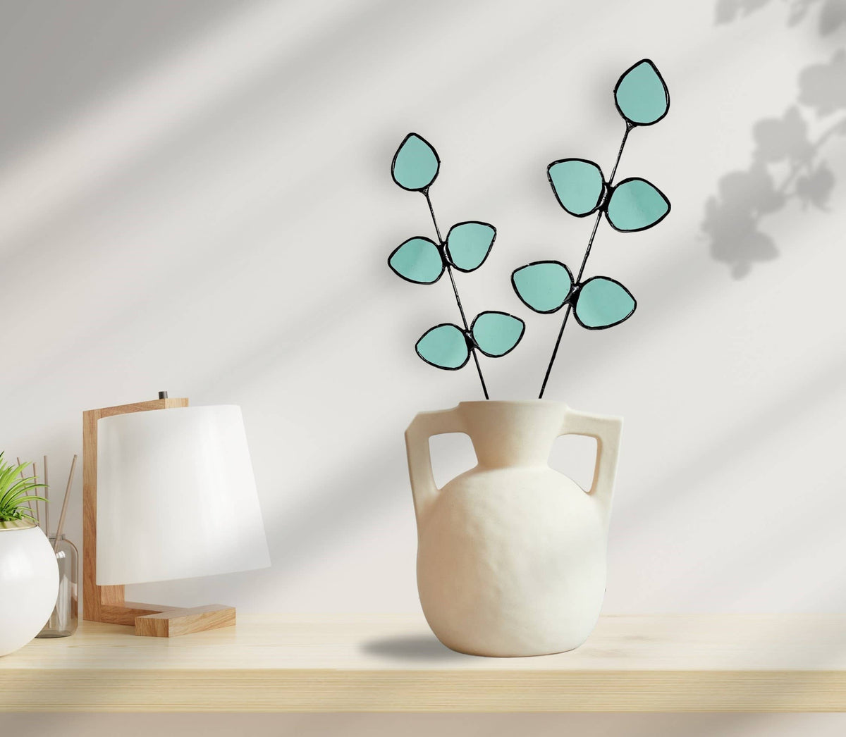 Bring a pop of color and artistry to your home with this handcrafted stained glass gumdrop eucalyptus stem by Samara Designs Studio. This stem is made from beautiful transparent seafoam green stained glass, cut and assembled by hand to create a lasting botanical accent that will never wilt or fade.