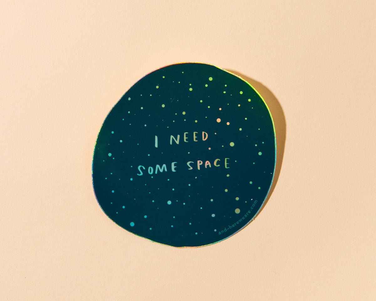 Give me some (literal) space okay? This holographic sticker for the overstimulated reads, "I Need Some Space." Featuring original artwork by Meghan Hopkins Sokorai, this durable, waterproof sticker is dishwasher safe and perfect for laptops, water bottles, notebooks, or anywhere you want to set boundaries with a little sparkle.