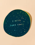 Give me some (literal) space okay? This holographic sticker for the overstimulated reads, "I Need Some Space." Featuring original artwork by Meghan Hopkins Sokorai, this durable, waterproof sticker is dishwasher safe and perfect for laptops, water bottles, notebooks, or anywhere you want to set boundaries with a little sparkle.