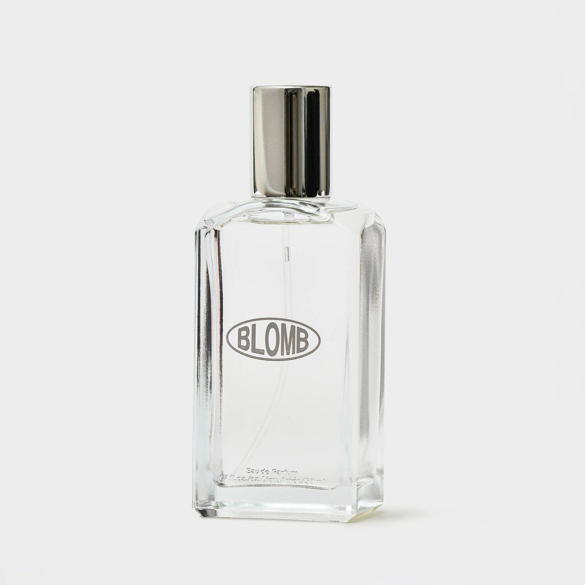 Clear glass Blomb perfume bottle with a silver cap on a gray background