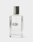 Clear glass Blomb perfume bottle with a silver cap on a gray background