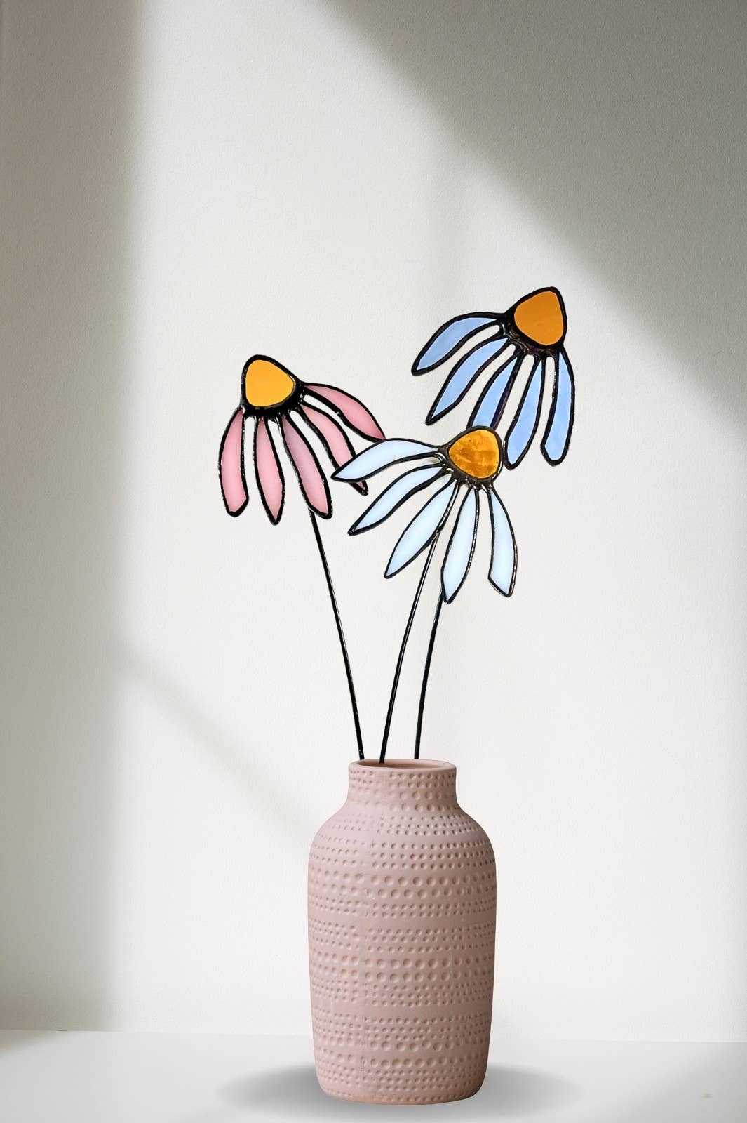 Stained glass coneflowers in pink, white and pale blue in a pink textured vase