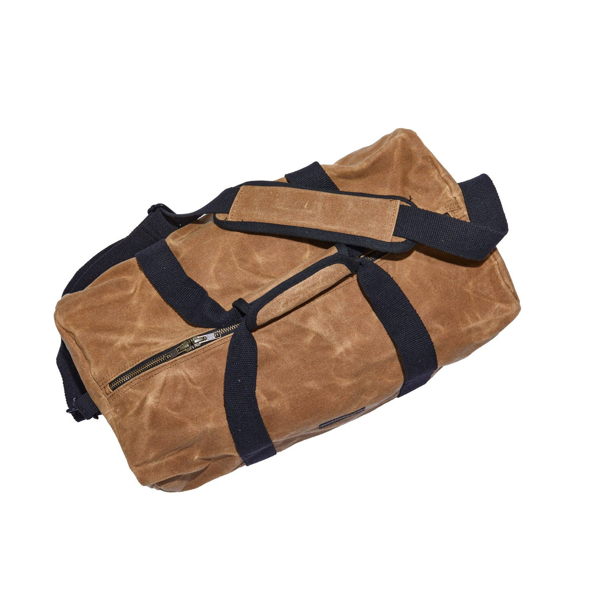 Tan waxed canvas duffel bag from above, showing the padded handle wrap and side zip pocket