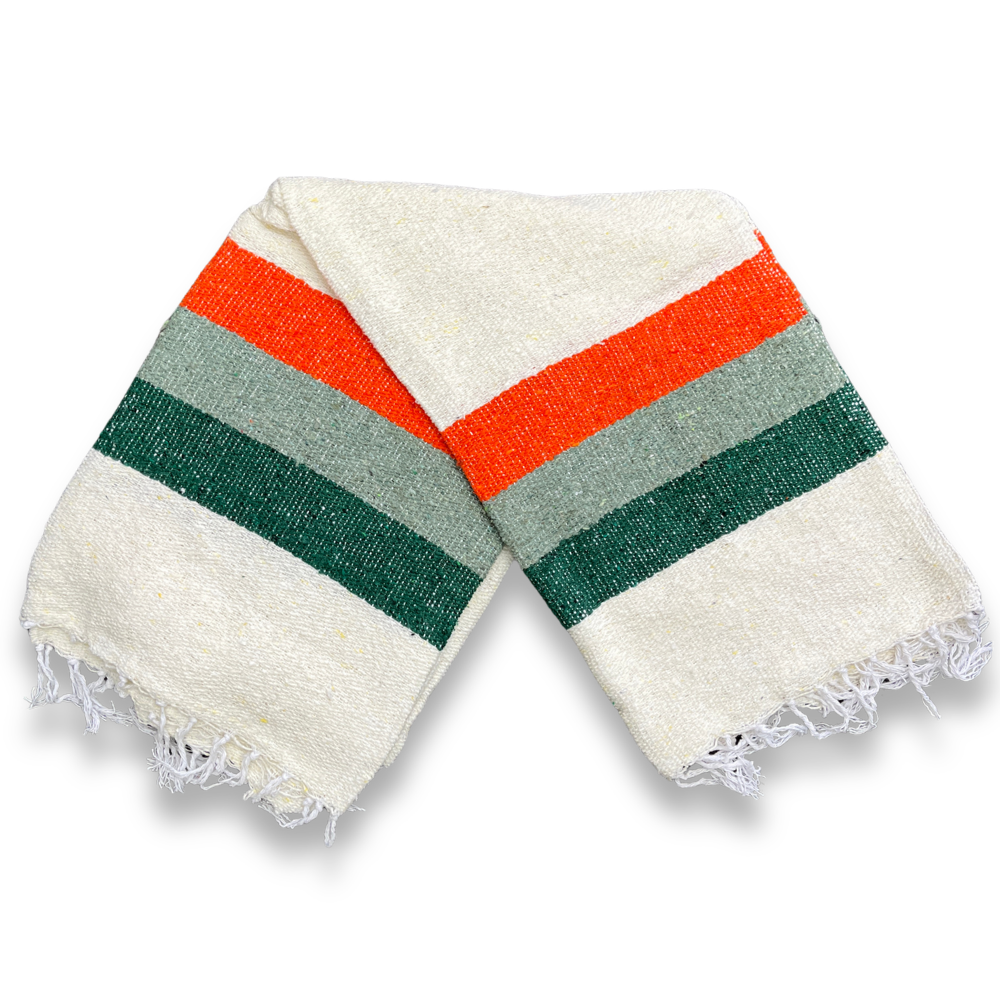 Cream Sea Breeze blanket with green, sage and orange stripes, folded in half on a white background