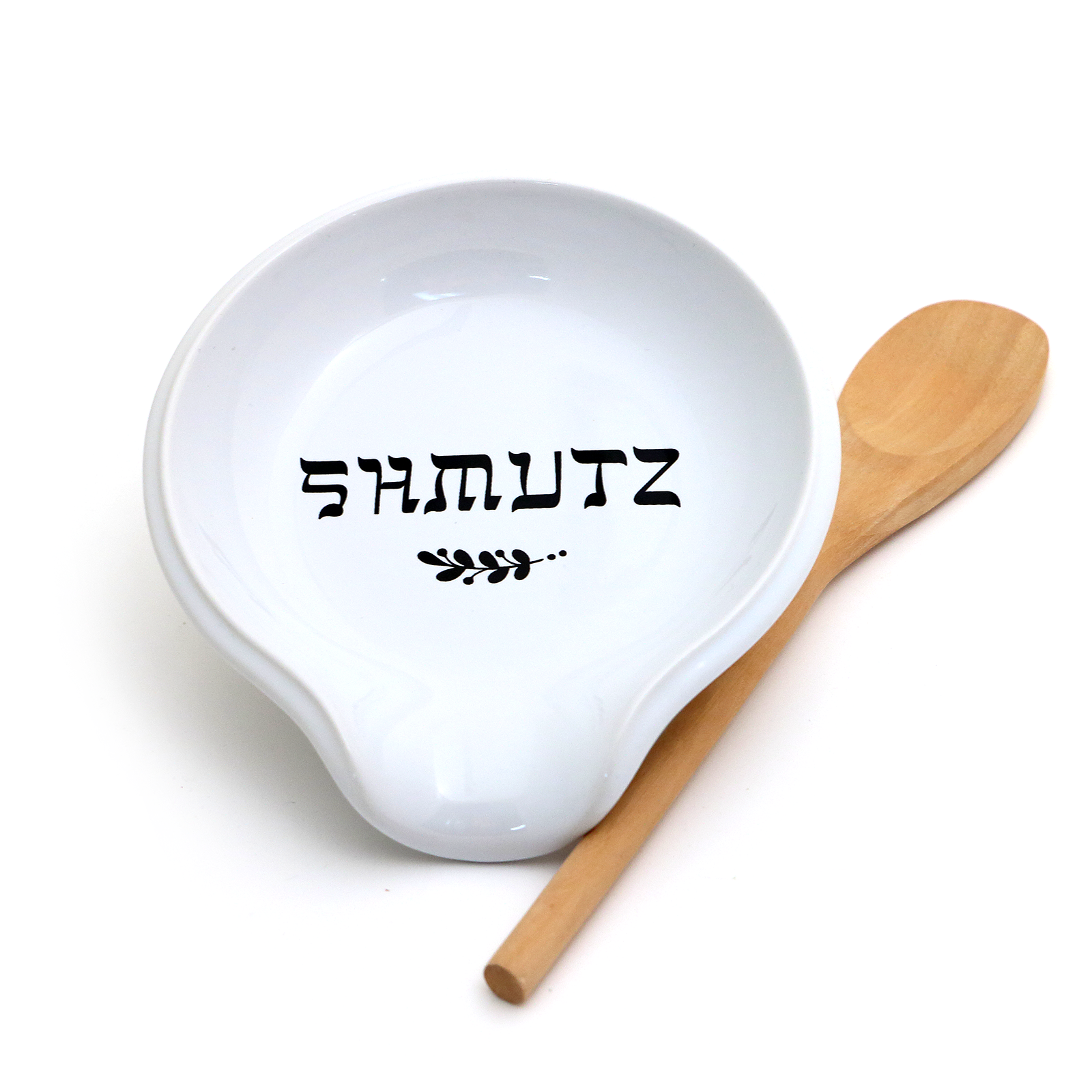 White bowl with 'SHMUTZ' text and a wooden spoon on a white background