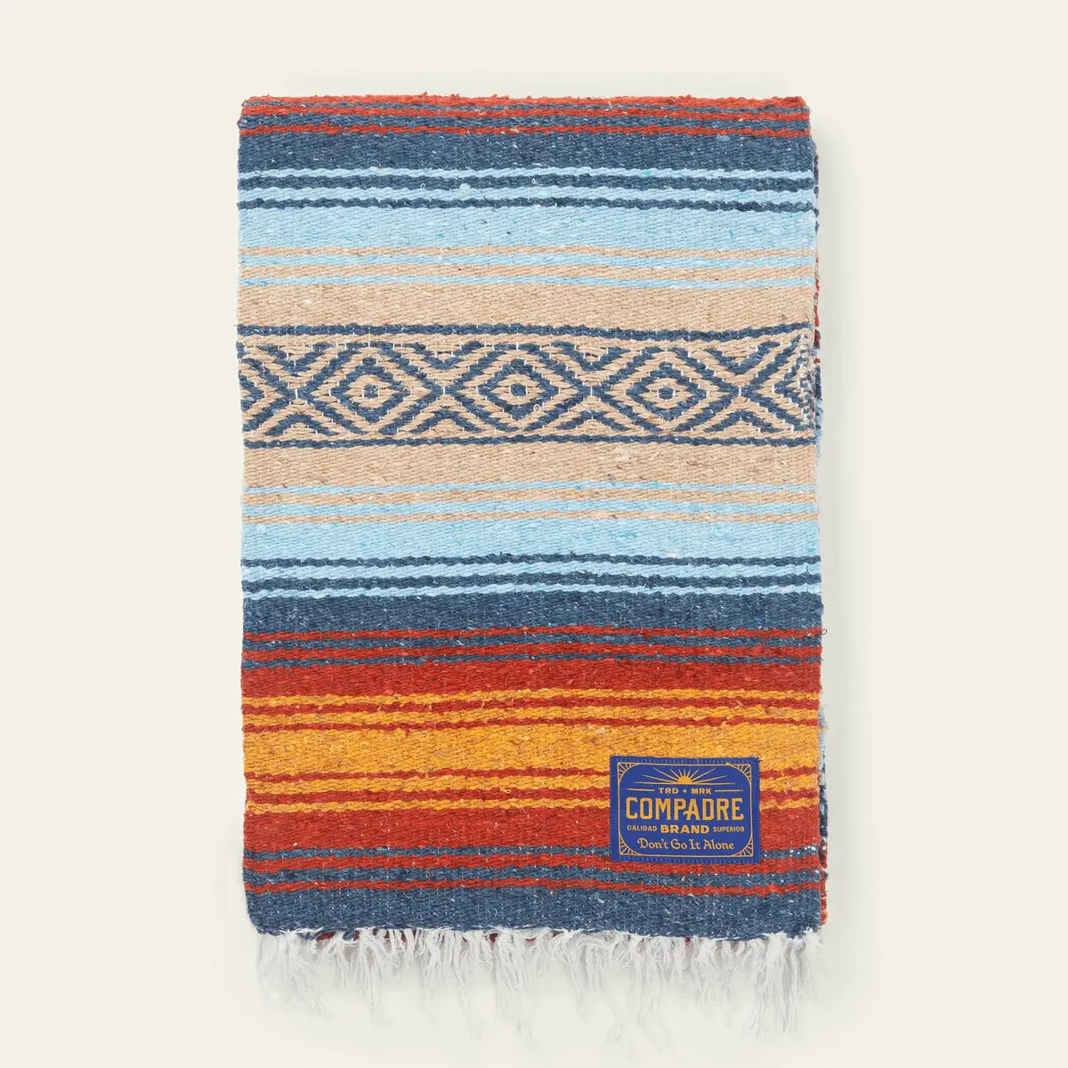 Falsa blanket in light blue, navy, orange and cream stripes with a diamond band