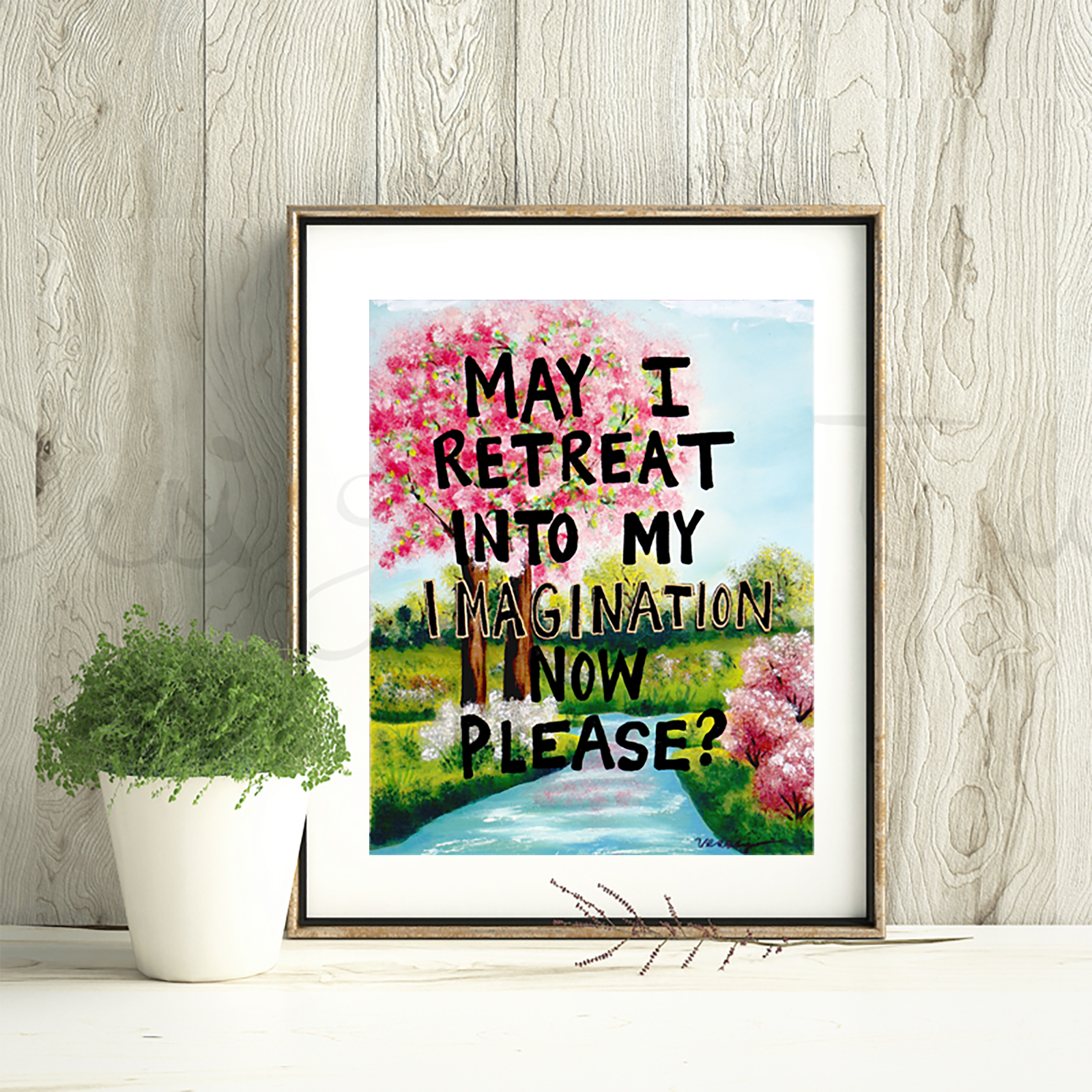 Framed artwork with a nature scene and text on a wooden wall.