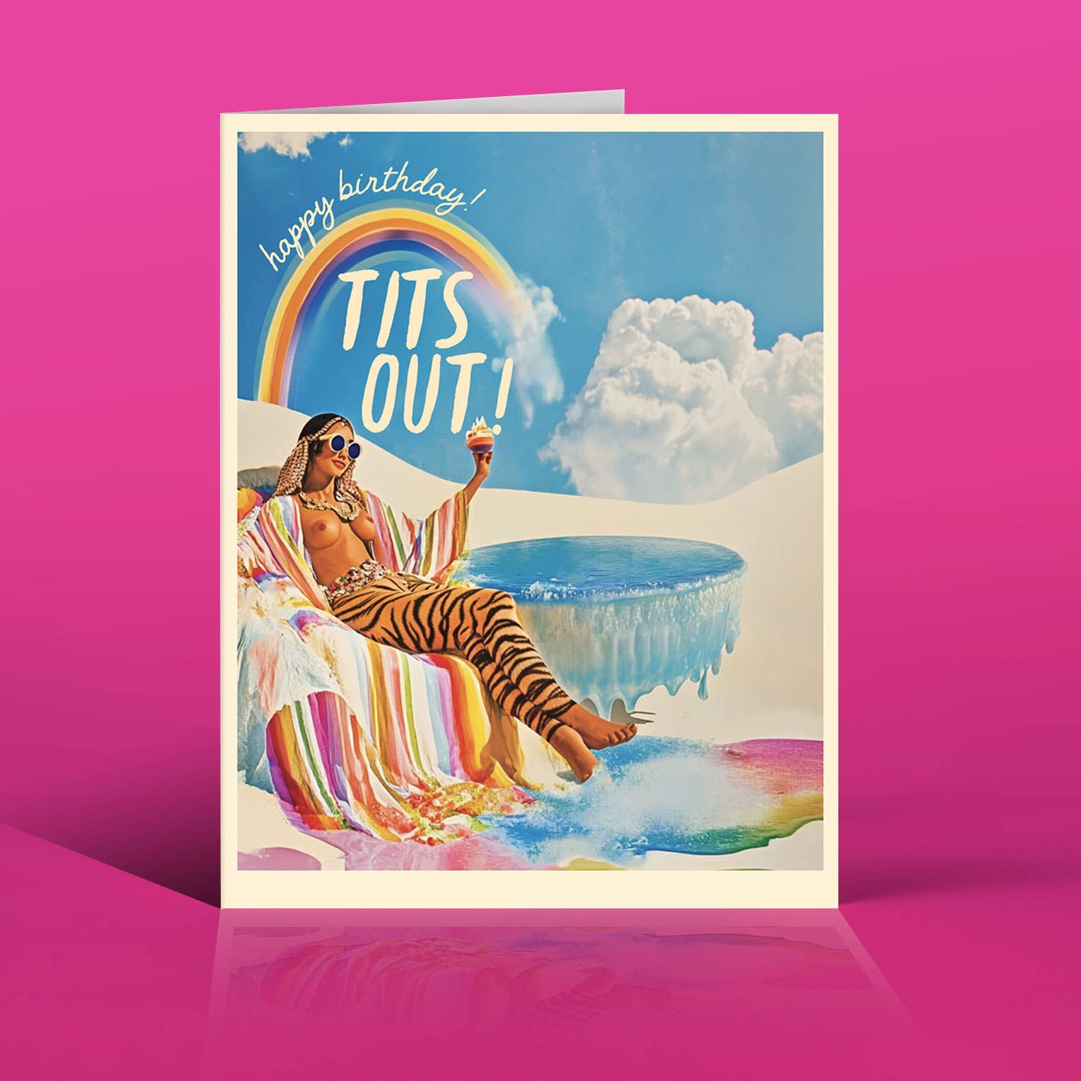 Birthday card with a person in a striped towel by a pool, rainbow, and 'happy birthday TITS OUT!' text on a pink background.