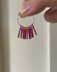 Crafted from durable 14k gold-filled or sterling silver and meticulously adorned with hand-beaded Japanese glass beads, the Kaleid Fringe Hoops are the ultimate expression of modern personality. These statement earrings don't just complement your look; they become the focal point of your ensemble.