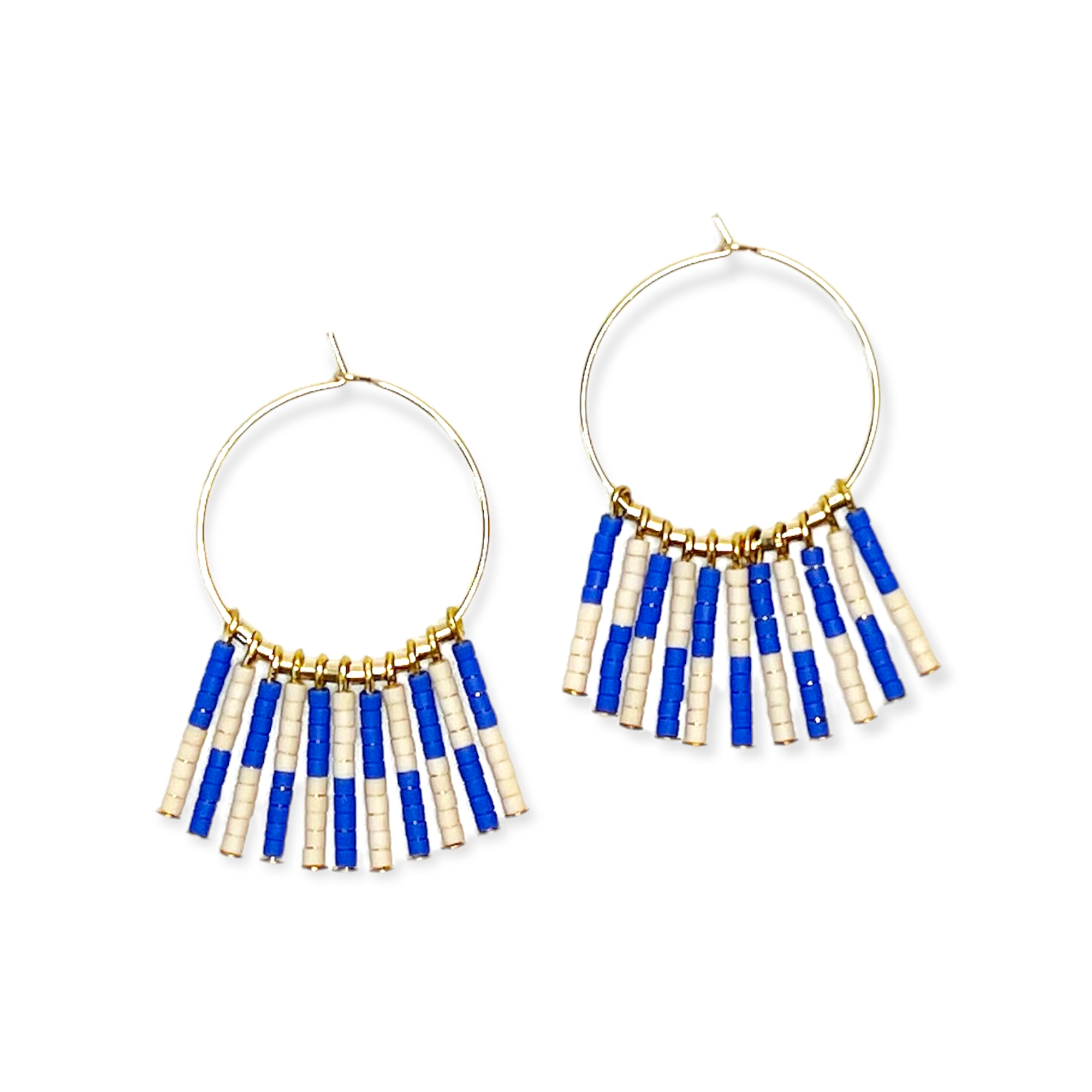 Crafted from durable 14k gold-filled or sterling silver and meticulously adorned with hand-beaded Japanese glass beads, the Kaleid Fringe Hoops are the ultimate expression of modern personality. These statement earrings don't just complement your look; they become the focal point of your ensemble.