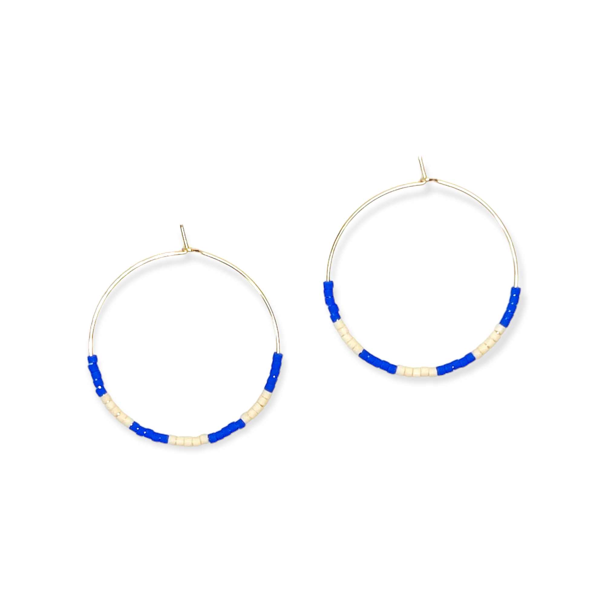 A pair of gold-filled hoop earrings with blue and white beaded details.
