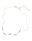 The Kaleid Necklace features an intricate hand-beaded pattern that dances in vibrant periwinkle and subdued cream. Crafted with care in our central Texas studio, the Kaleid Necklace boasts a 14k gold-filled or sterling silver chain adorned meticulously with Japanese glass beads. Each element reflects a dedication to modern luxury and artisanal precision.&nbsp;