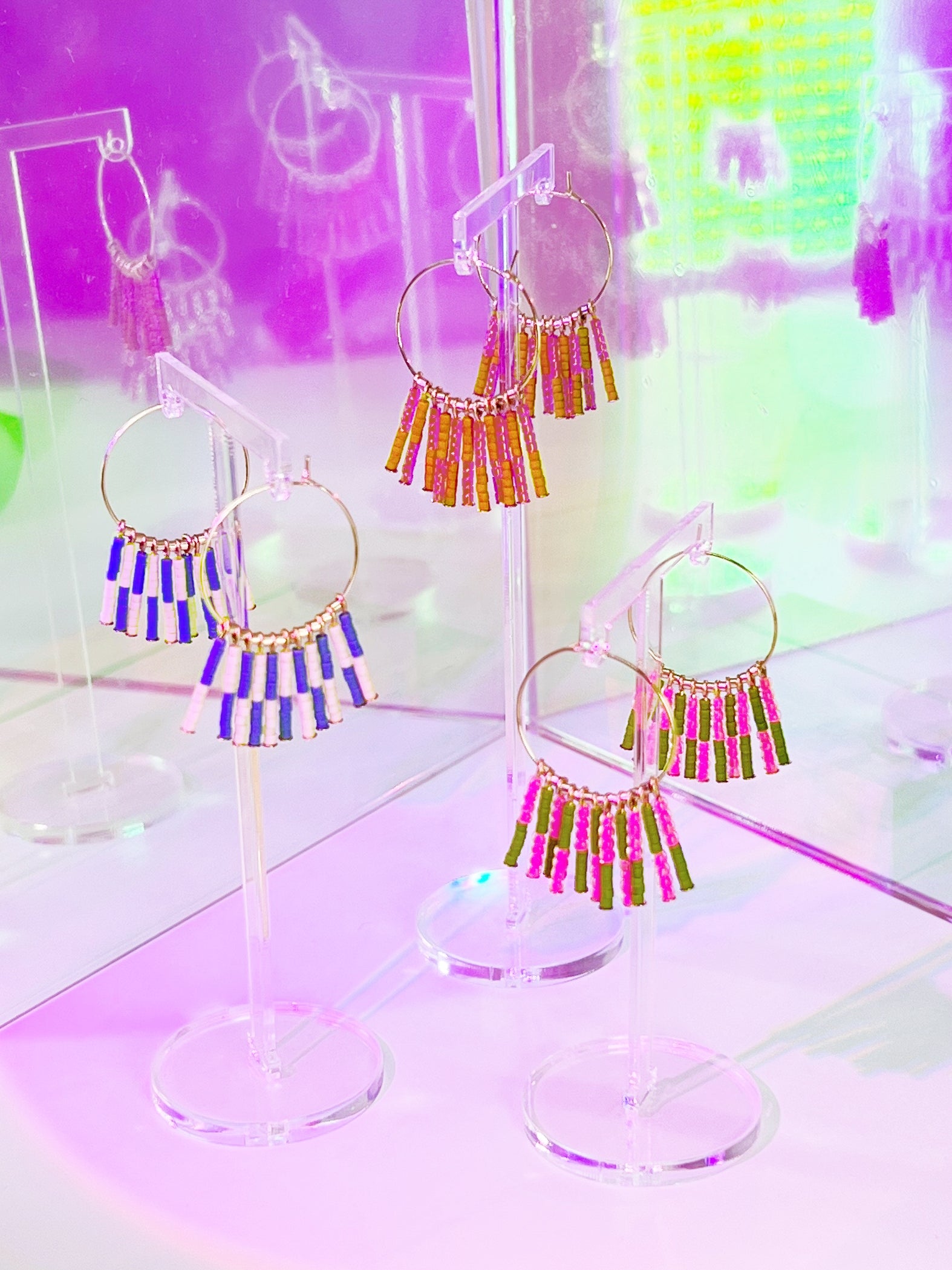 Crafted from durable 14k gold-filled or sterling silver and meticulously adorned with hand-beaded Japanese glass beads, the Kaleid Fringe Hoops are the ultimate expression of modern personality. These statement earrings don't just complement your look; they become the focal point of your ensemble.
